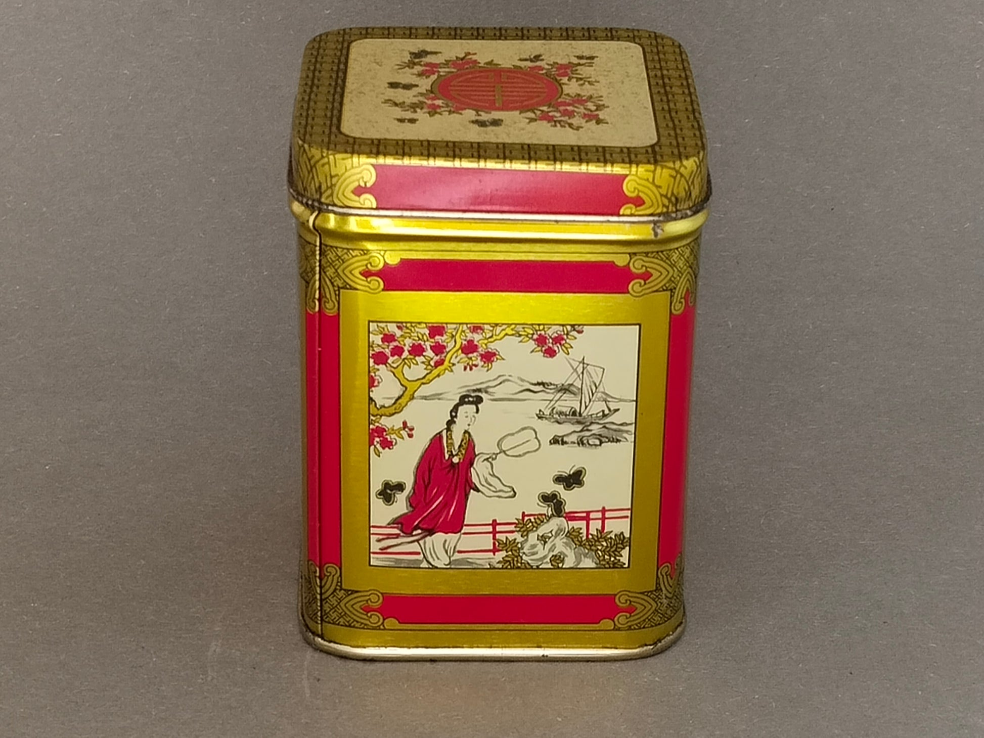 Vintage Teedose aus Blech mit rot-goldenem Chinoiserie-Dekor, Gesamtansicht der Vorderseite
