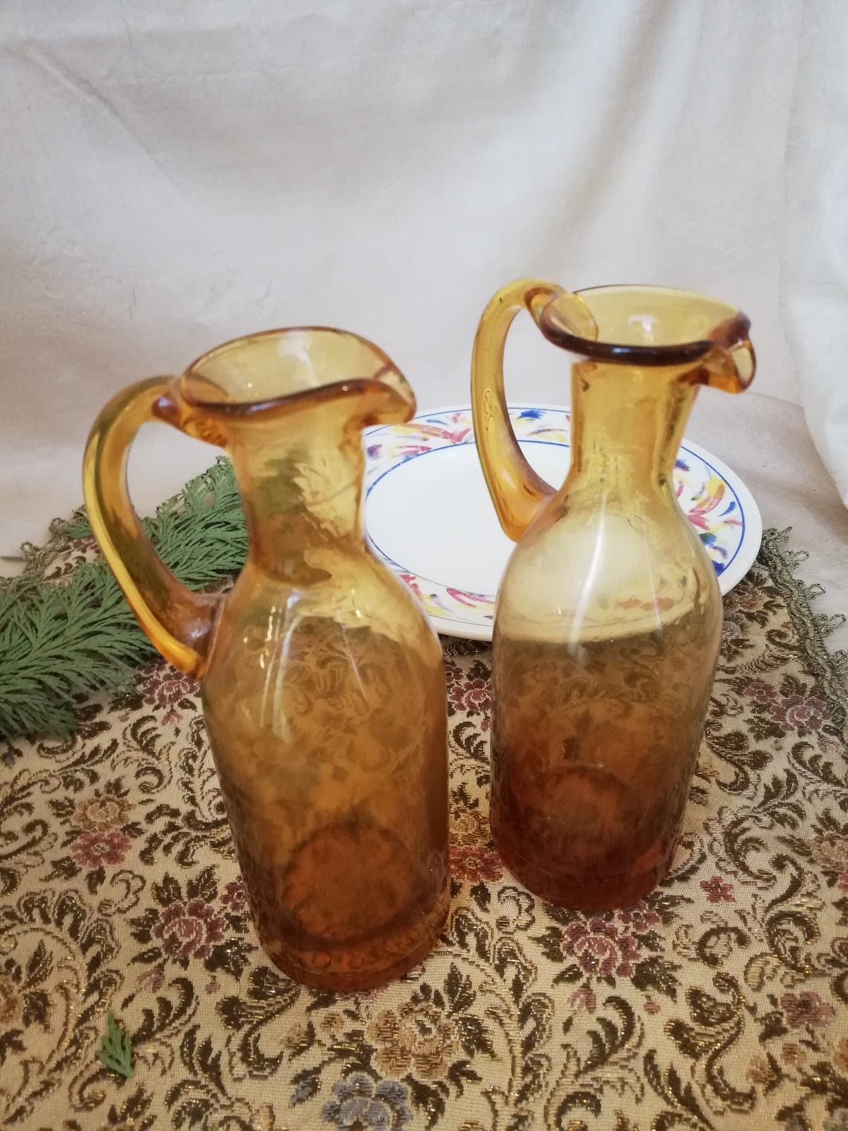 Two amber condiment bottles for oil and vinegar.