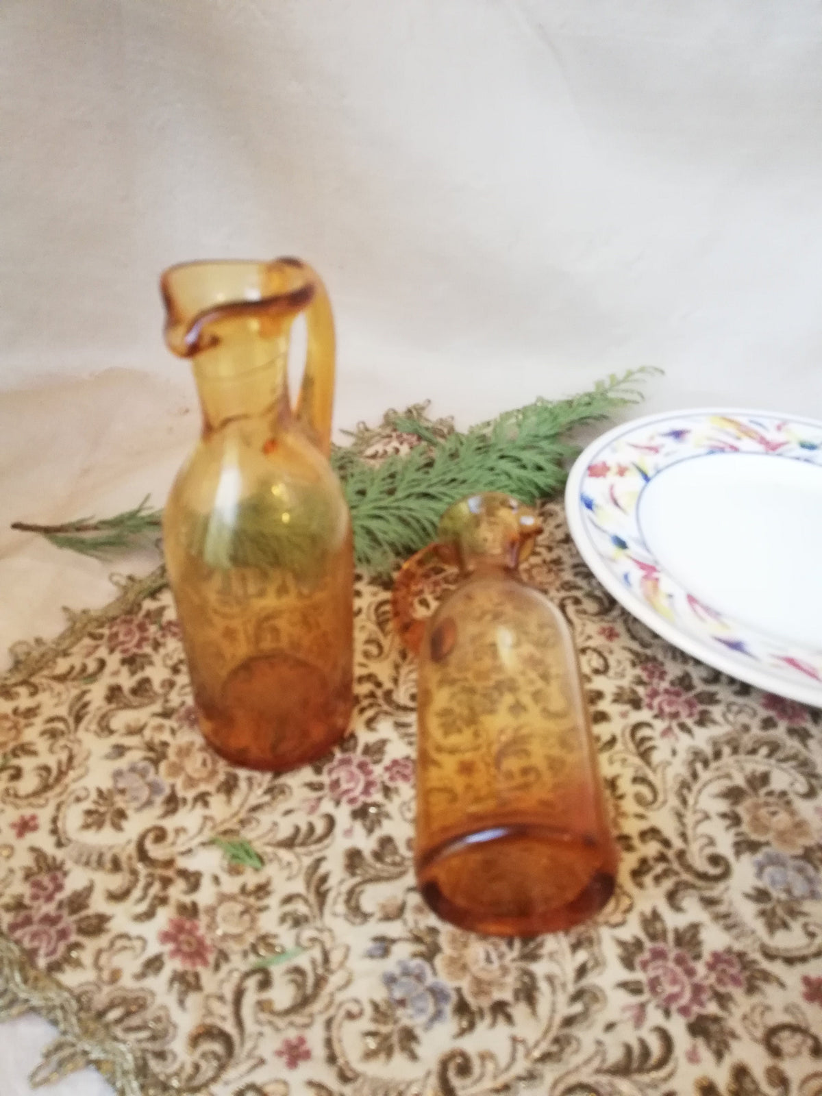 Two amber condiment bottles for oil and vinegar.