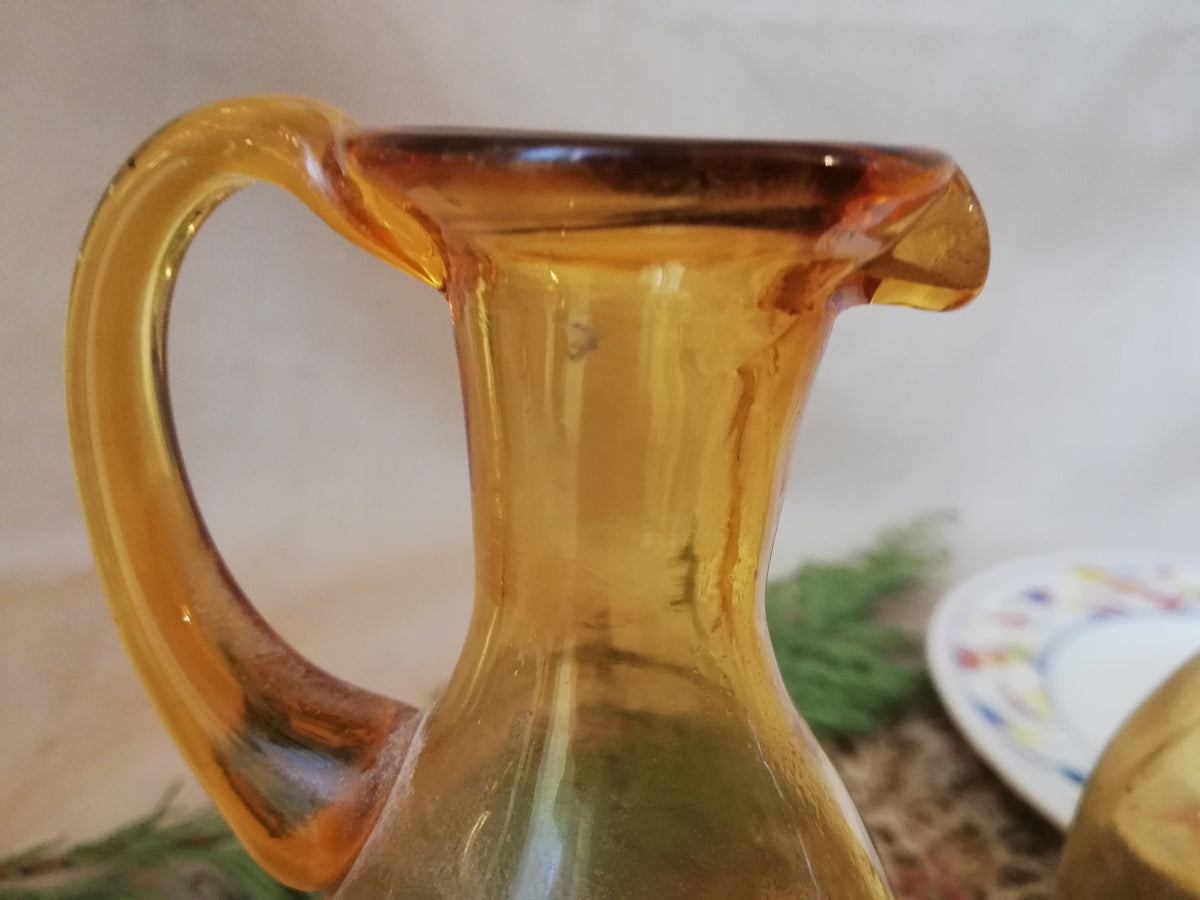 Two amber condiment bottles for oil and vinegar.