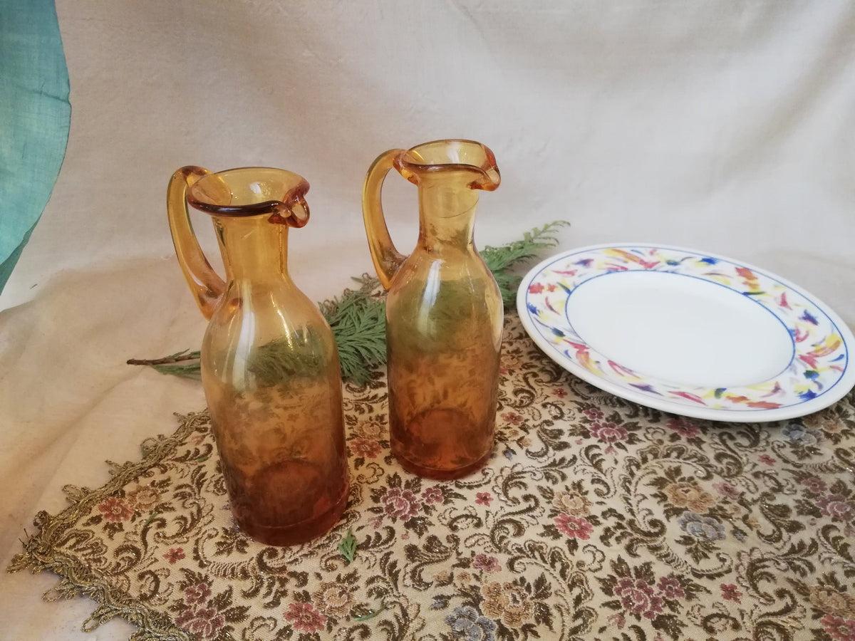 Two amber condiment bottles for oil and vinegar.