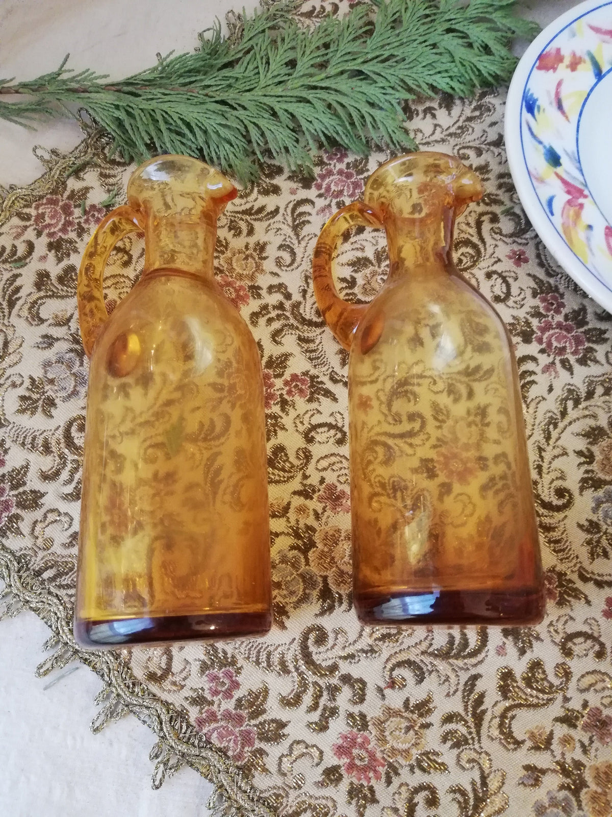 Two amber condiment bottles for oil and vinegar.