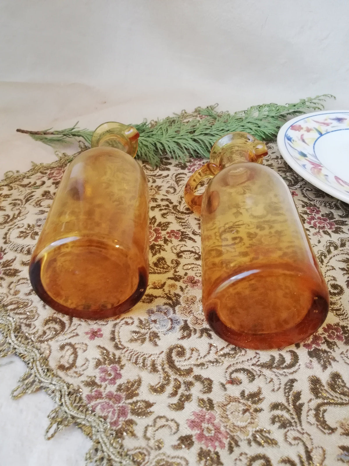 Two amber condiment bottles for oil and vinegar.
