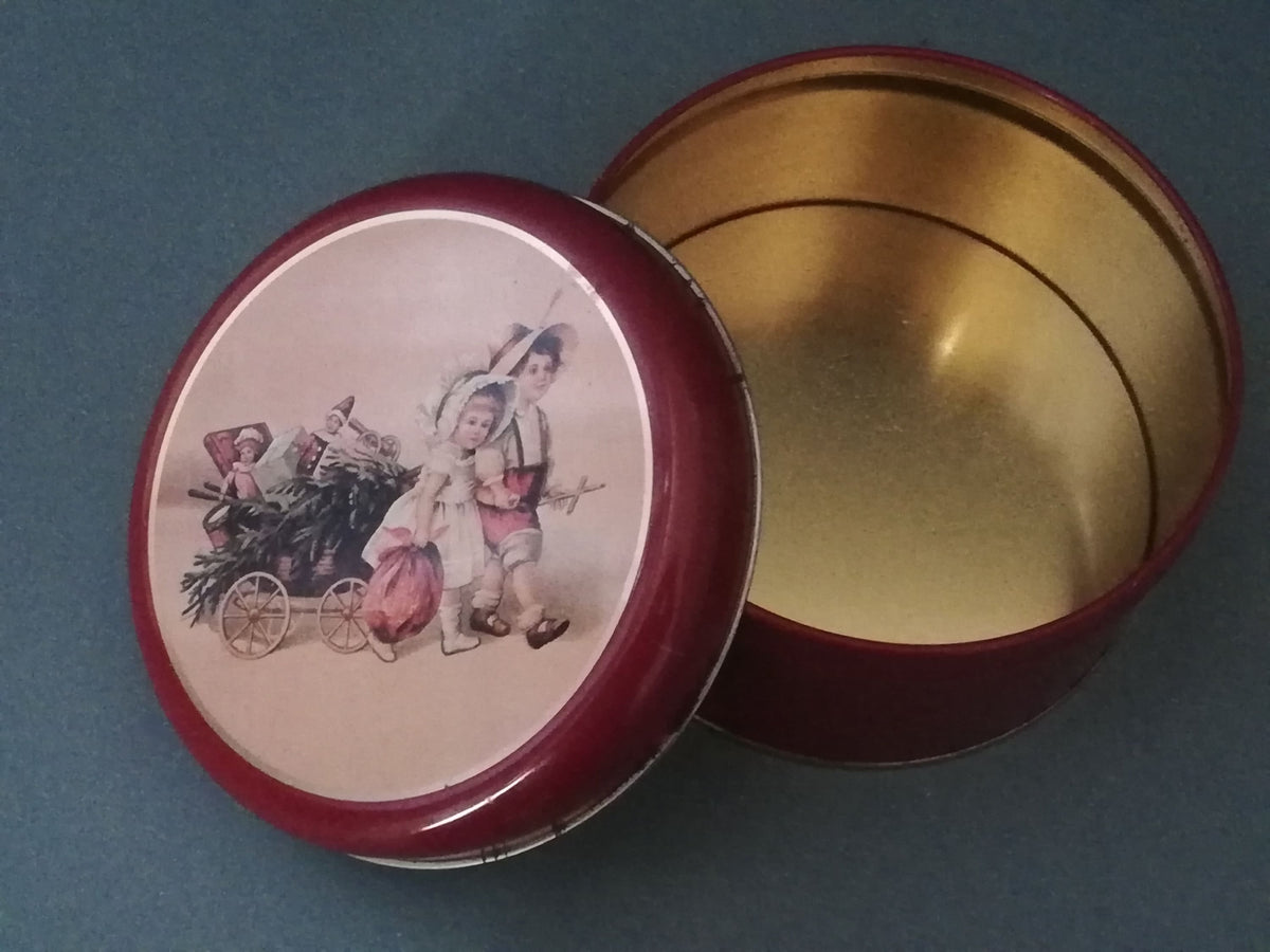 Red tin can with children playing, children pulling a cart with a Christmas tree and gifts, tin can for collectors, ,