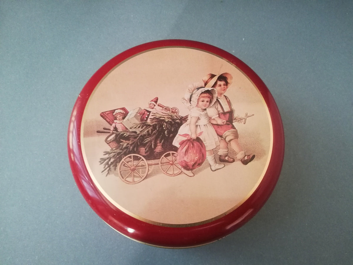 Red tin can with children playing, children pulling a cart with a Christmas tree and gifts, tin can for collectors, ,