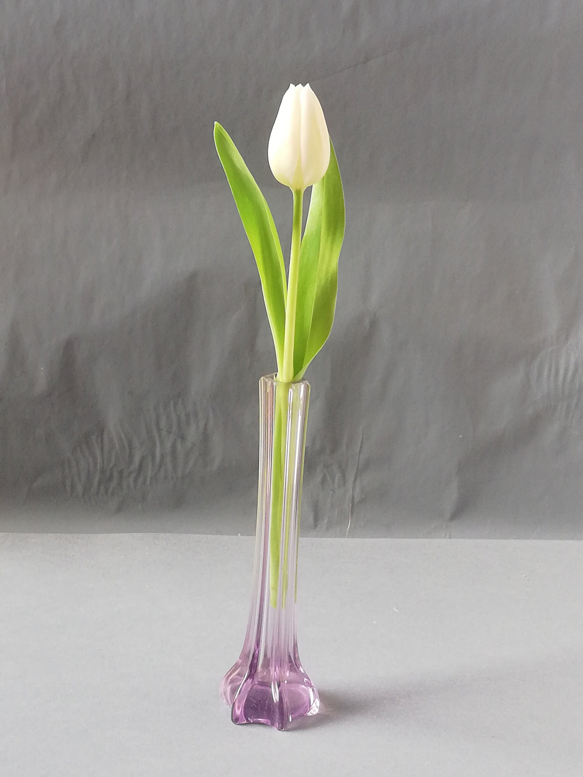 Elegant, narrow flower vase for single-stemmed flowers. graceful vase for the lunch table, purple vase as a flower decoration,