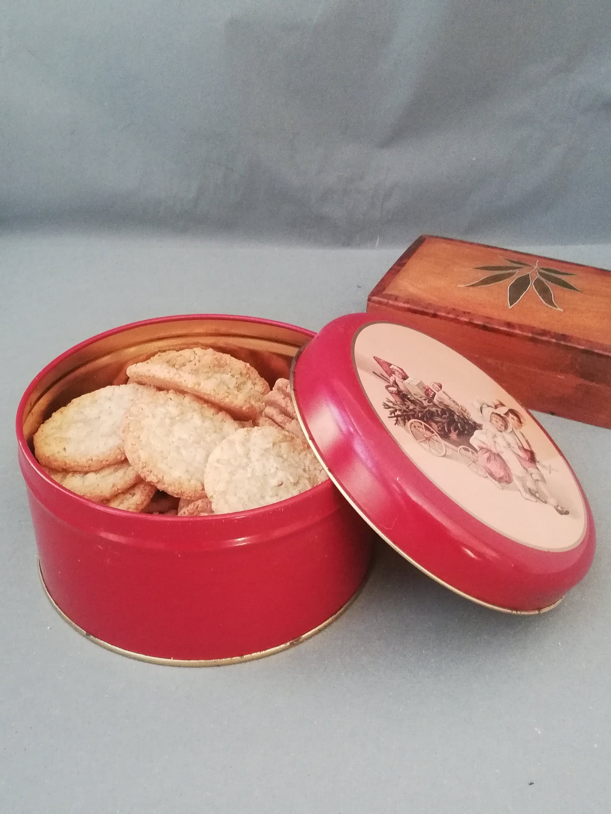Red tin can with children playing, children pulling a cart with a Christmas tree and gifts, tin can for collectors, ,