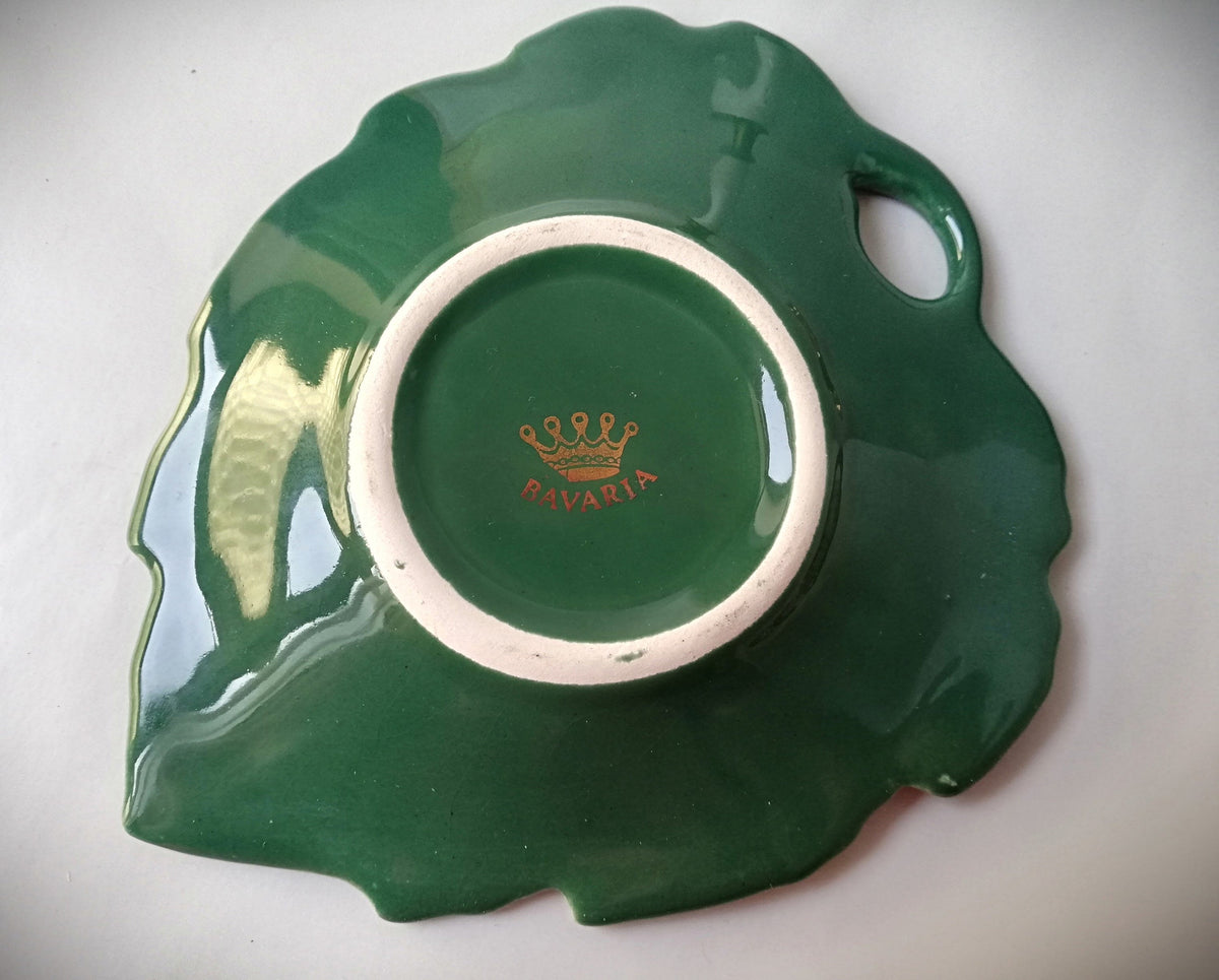Stylish vintage coaster in the shape of a green vine leaf with gold trim