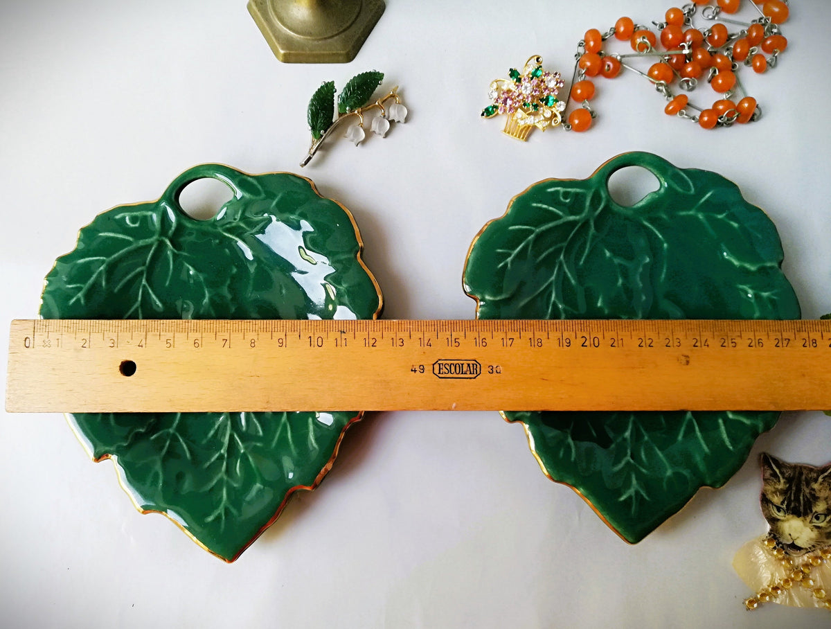 Stylish vintage coaster in the shape of a green vine leaf with gold trim
