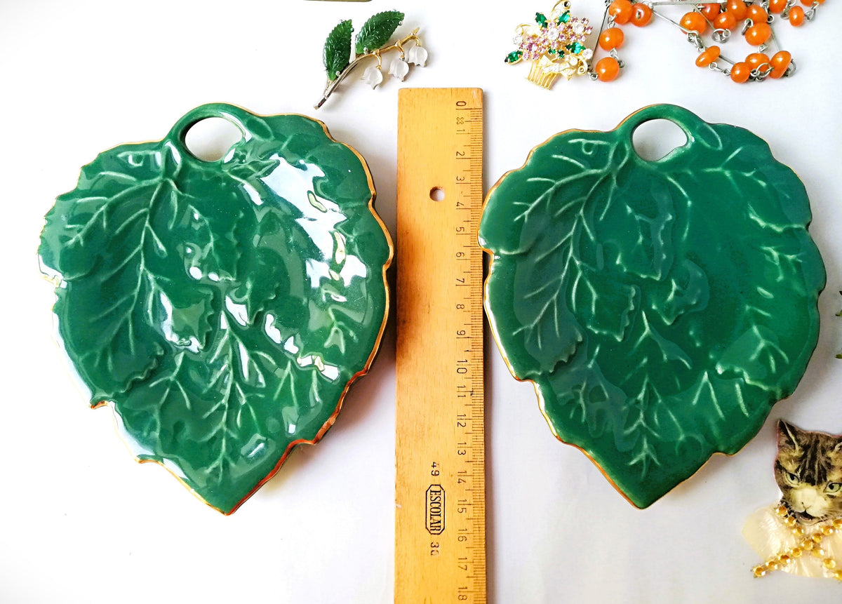 Stylish vintage coaster in the shape of a green vine leaf with gold trim