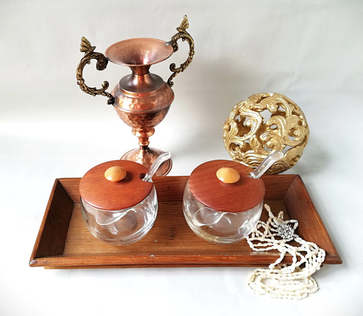 Glass jars with wooden lids and spoons for serving side dishes. Serving dishes for side dishes such as jam, ketchup, horseradish or caviar.