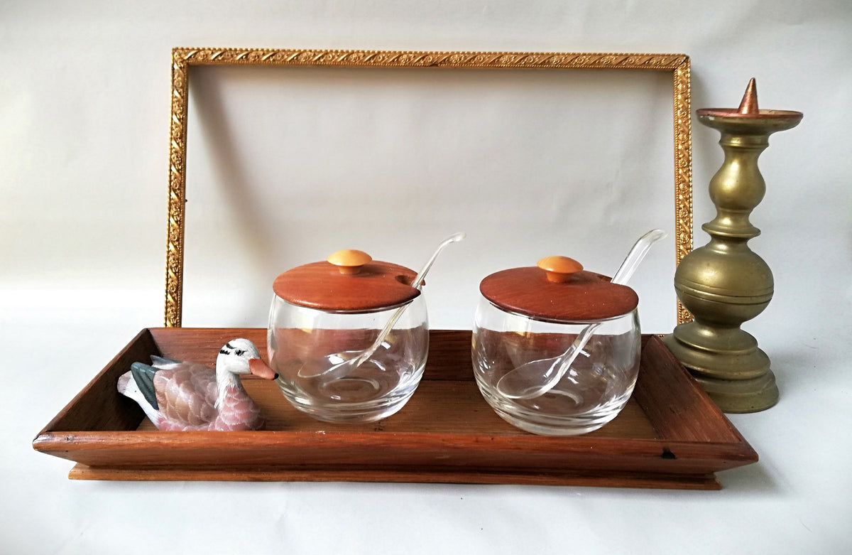 Glass jars with wooden lids and spoons for serving side dishes. Serving dishes for side dishes such as jam, ketchup, horseradish or caviar.