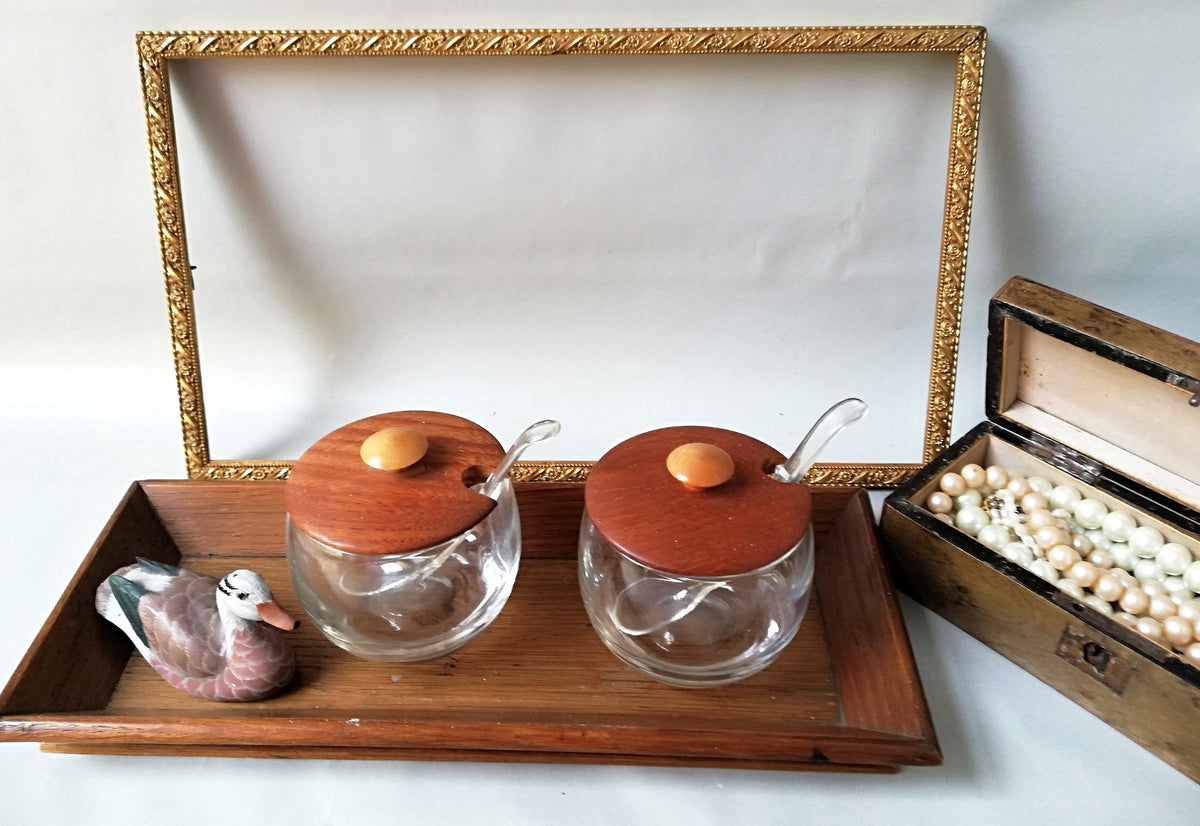 Glass jars with wooden lids and spoons for serving side dishes. Serving dishes for side dishes such as jam, ketchup, horseradish or caviar.