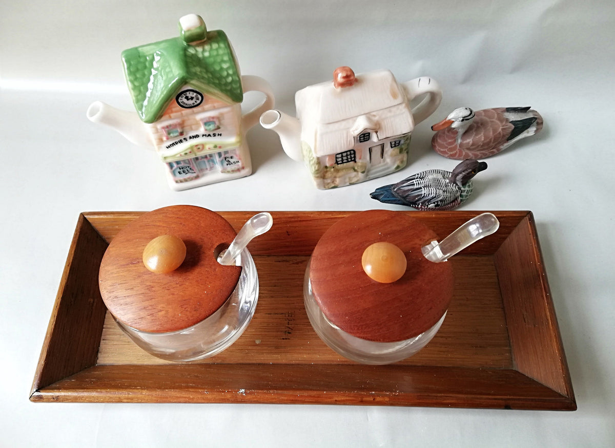 Glass jars with wooden lids and spoons for serving side dishes. Serving dishes for side dishes such as jam, ketchup, horseradish or caviar.