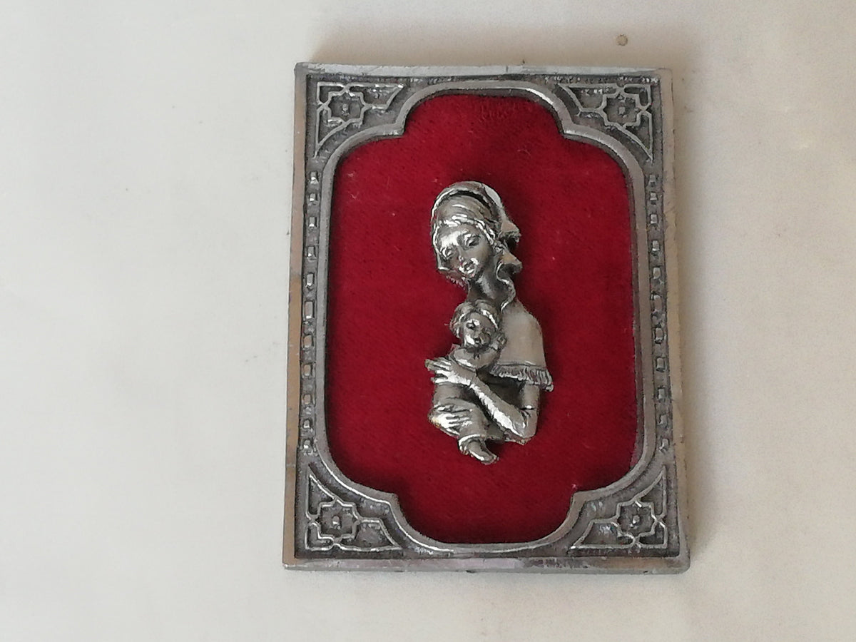 Vintage Madonna and Child on red velvet. Miniature icon with zinc frame and Madonna made of zinc.
