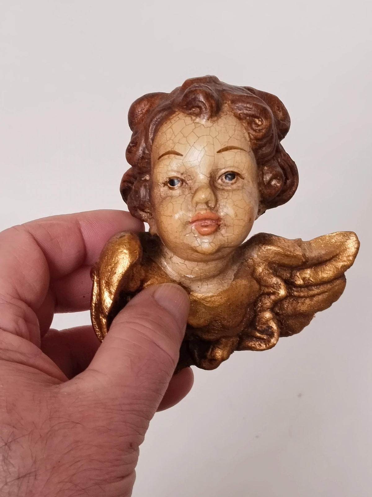 Größenvergleich des Holz-Engelskopfes in der Hand