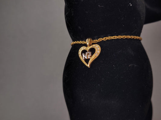 Vintage Nina Ricci Halskette mit Herzanhänger, NR-Logo und Kristallbesatz in Gold- und Silberton