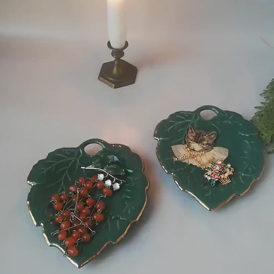 Stylish vintage coaster in the shape of a green vine leaf with gold trim