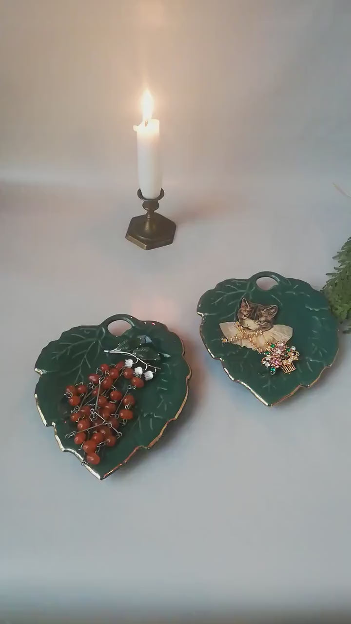 Stylish vintage coaster in the shape of a green vine leaf with gold trim