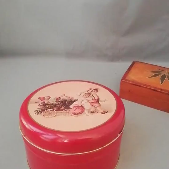 Red tin can with children playing, children pulling a cart with a Christmas tree and gifts, tin can for collectors, ,