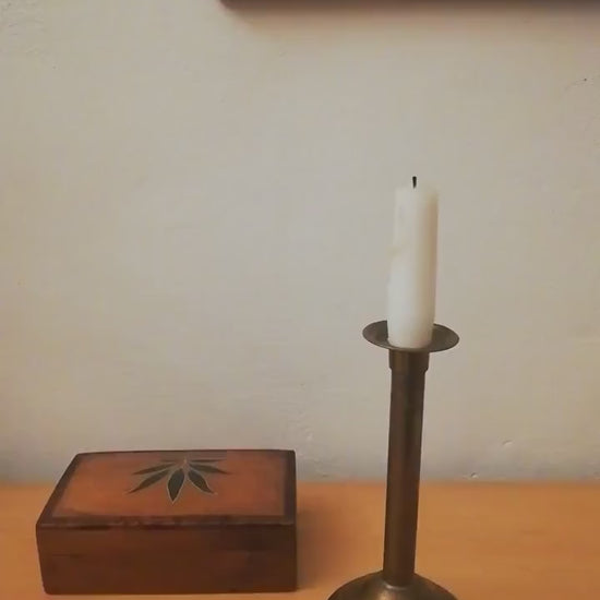 An antique brass candle holder, candle holder for a romantic dinner, candle lighting for romantic hours