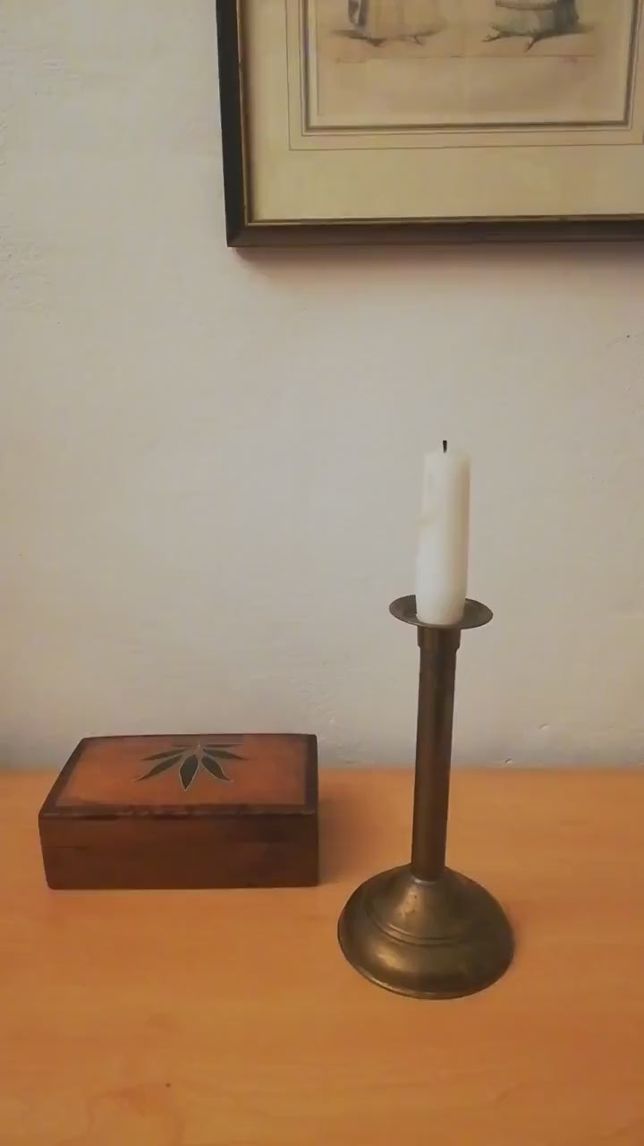 An antique brass candle holder, candle holder for a romantic dinner, candle lighting for romantic hours