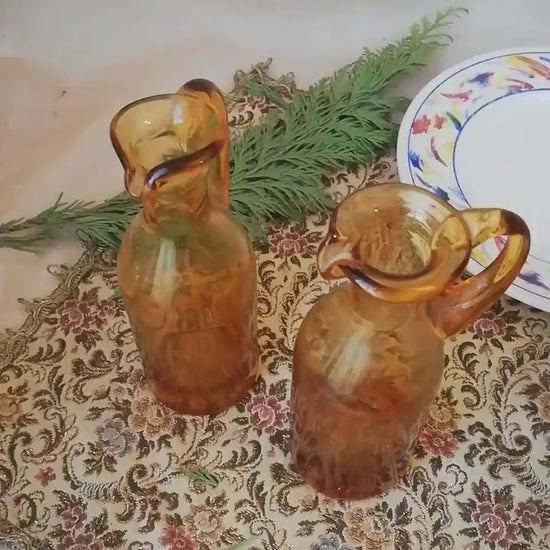 Two amber condiment bottles for oil and vinegar.