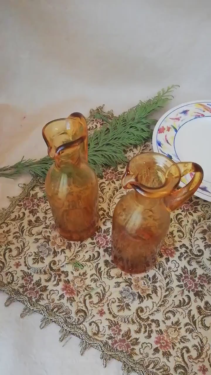 Two amber condiment bottles for oil and vinegar.